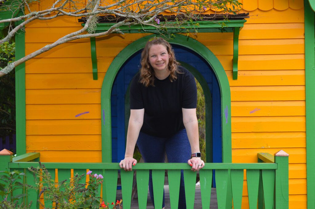 Ashlea standing in front of playhouse.