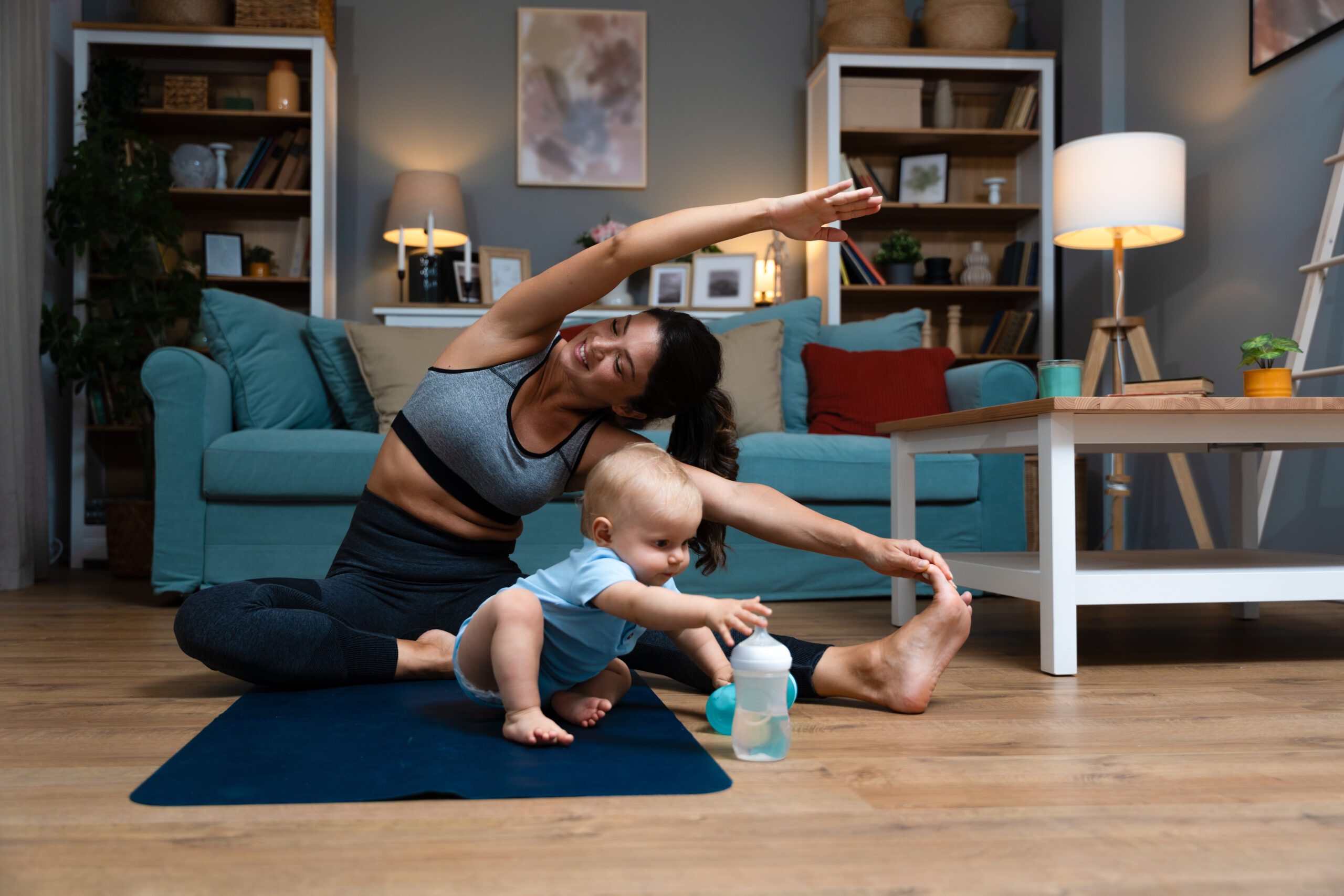 Postpartum mom stretching with baby